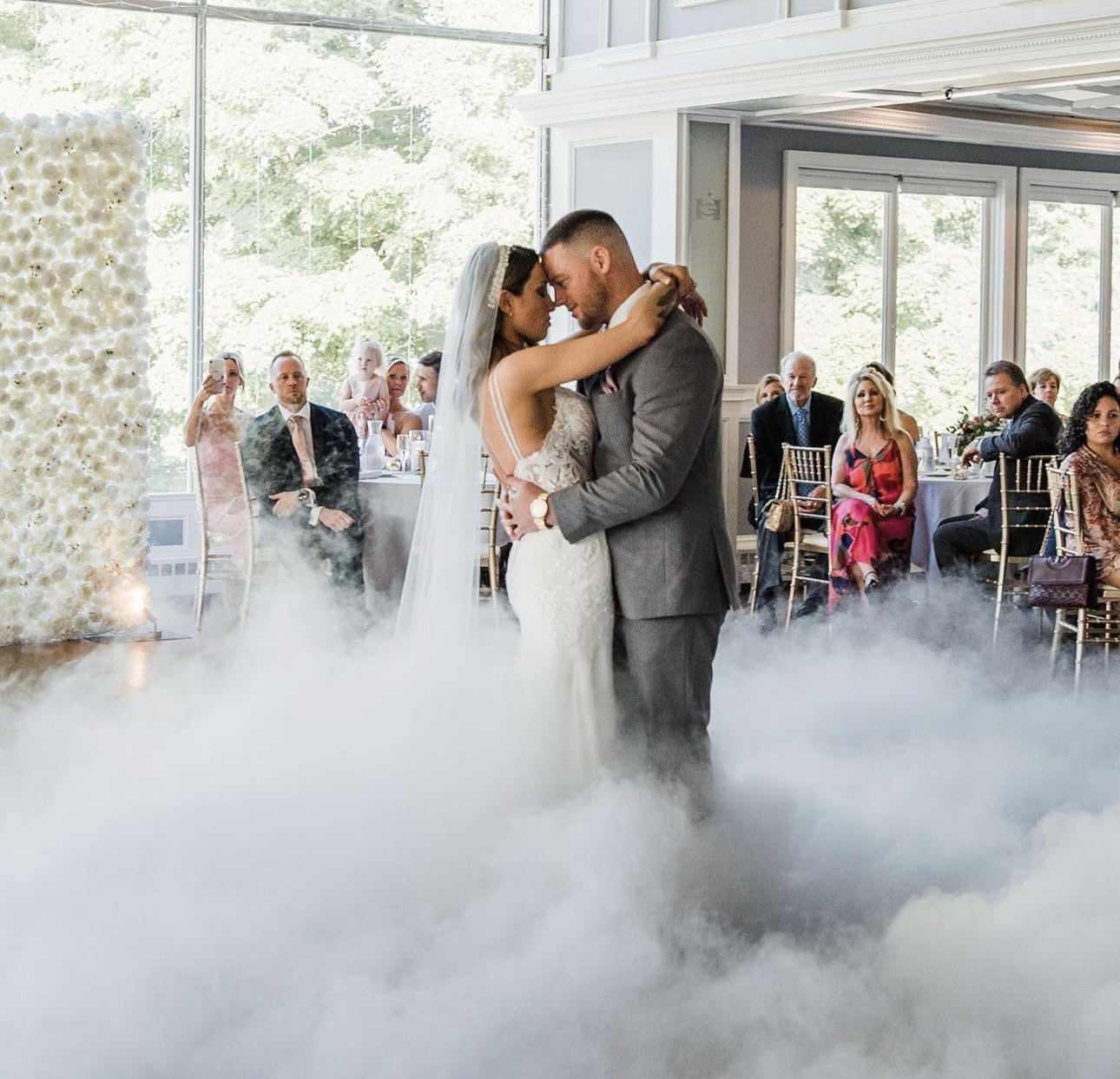Couple sharing their first dance on a low cloud of fog
