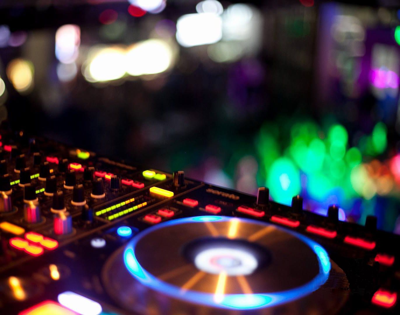 DJ controller lit up in a dark venue