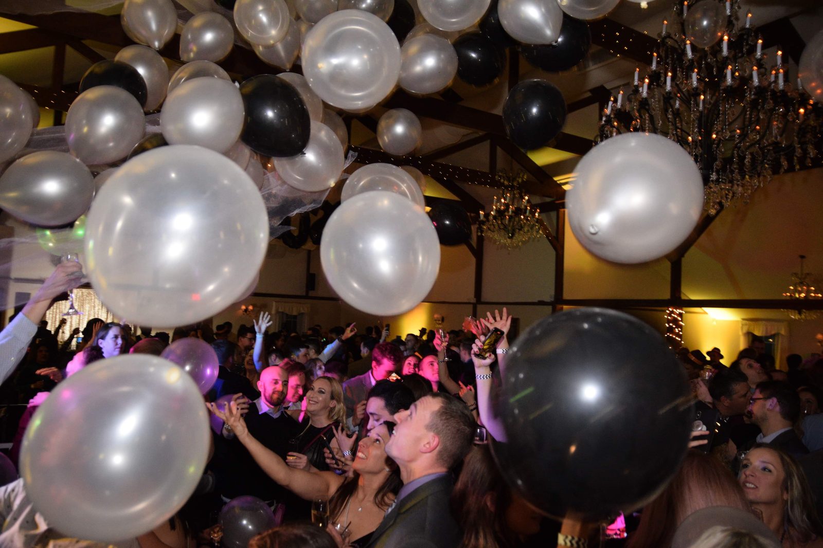 Guests celebrating under balloons at a private party
