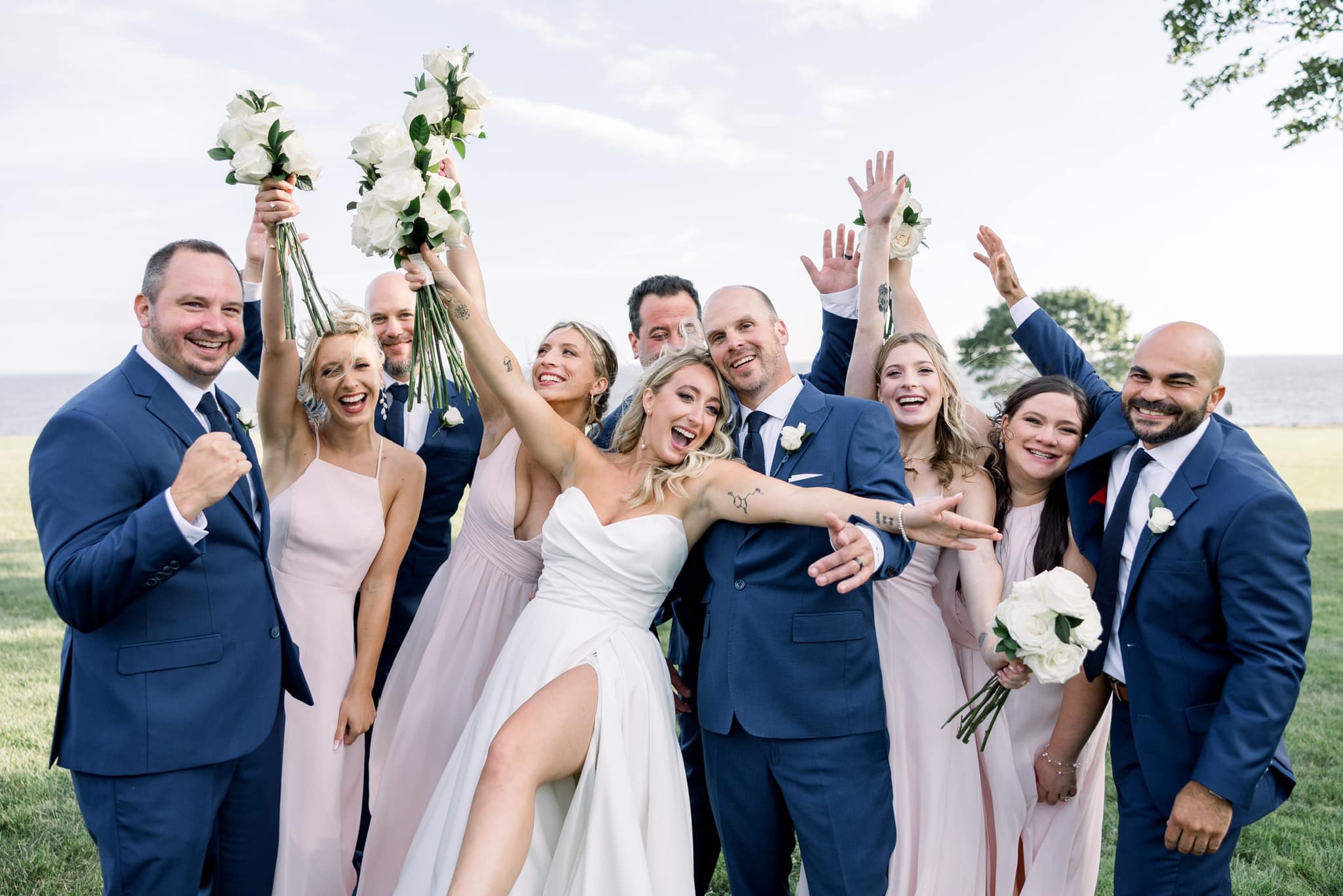 Wedding party cheering with bouquets