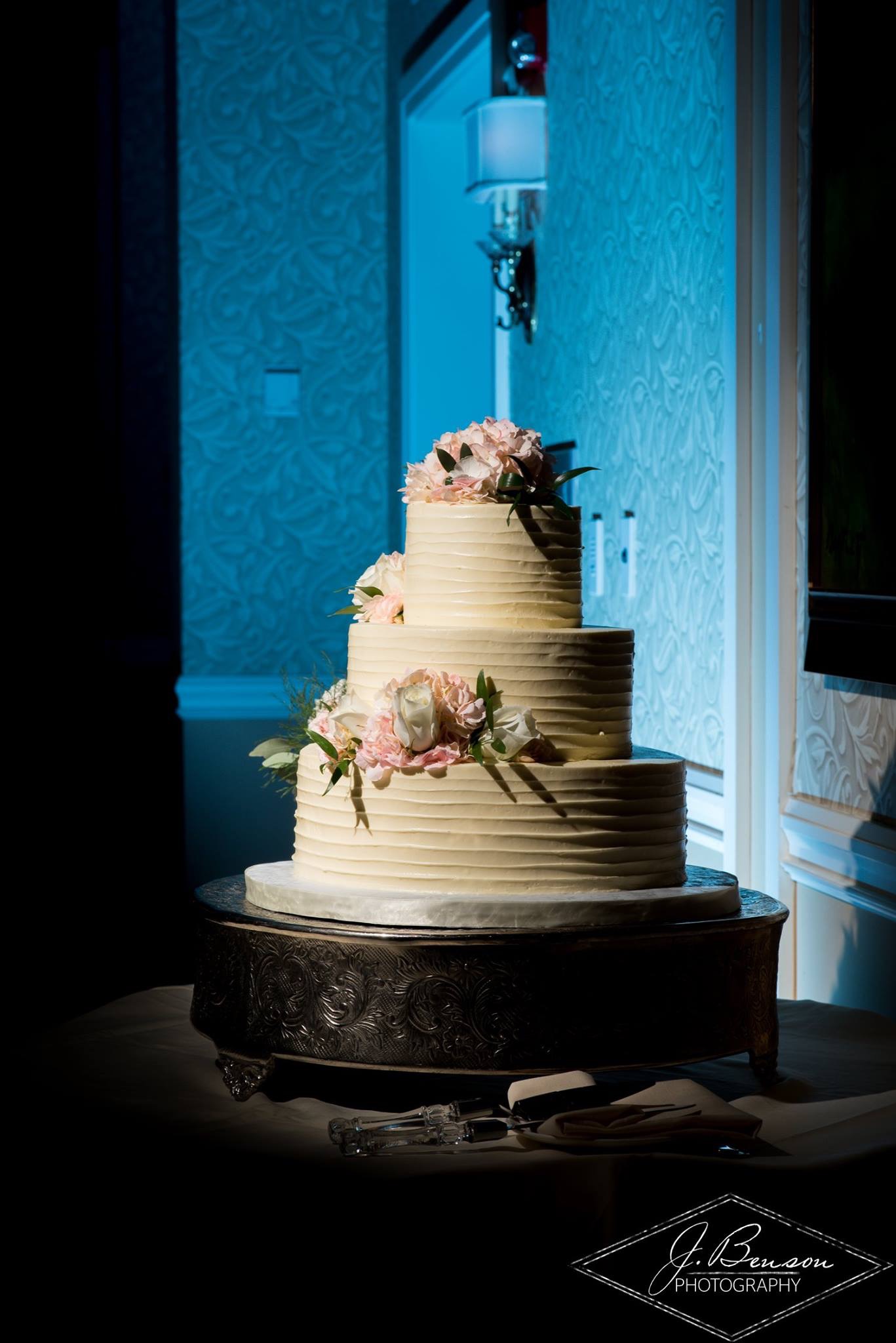 Wedding cake glowing under blue up-lighting